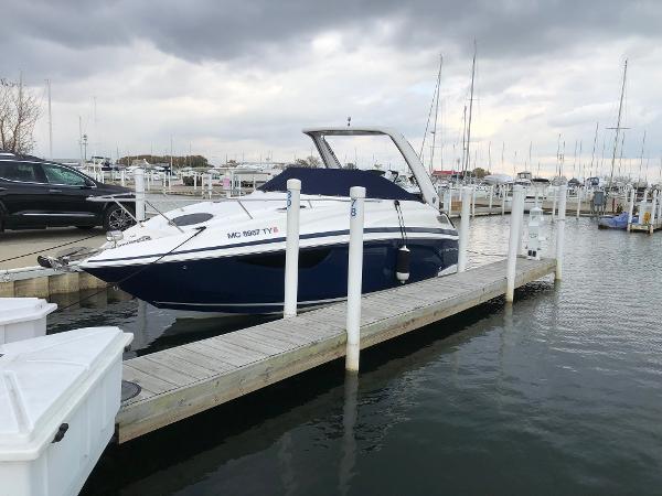 Regal 28 Express 2014 Regal 28 Express boat docked at a marina under cloudy skies.