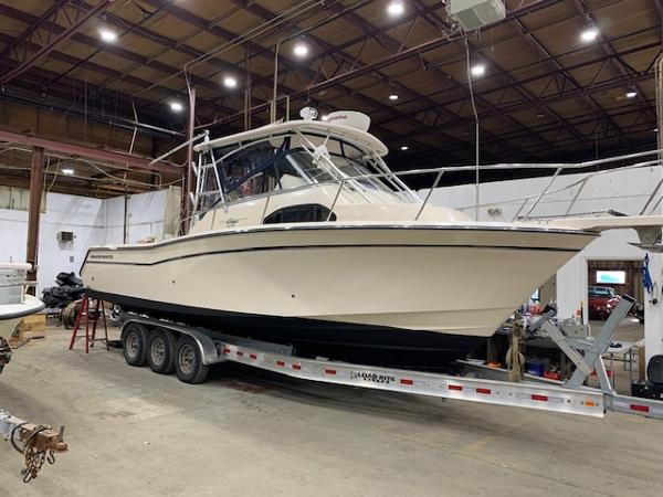 Grady-White Marlin 300 2006 Grady-White Marlin 300 boat on trailer in warehouse setting.