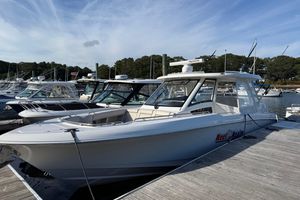 Boston Whaler 350 Realm 2020 Boston Whaler 350 Realm boat docked at a marina under a clear sky.