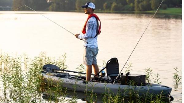 Native Watercraft Falcon 11 Man fishing on a 2023 Native Watercraft Falcon 11 kayak in a serene lake.