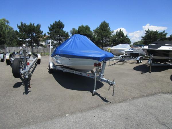 Stingray 186CC 2019 Stingray 186CC boat with blue cover on trailer in parking lot.