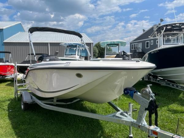 Bayliner M15 2024 Bayliner M15 boat on trailer, displayed outdoors.