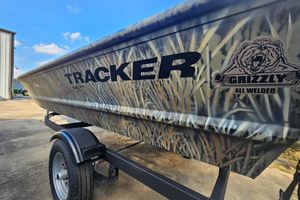 Tracker Grizzly 1648 Utility 2026 Tracker Grizzly 1648 Utility boat with camo design on a trailer.