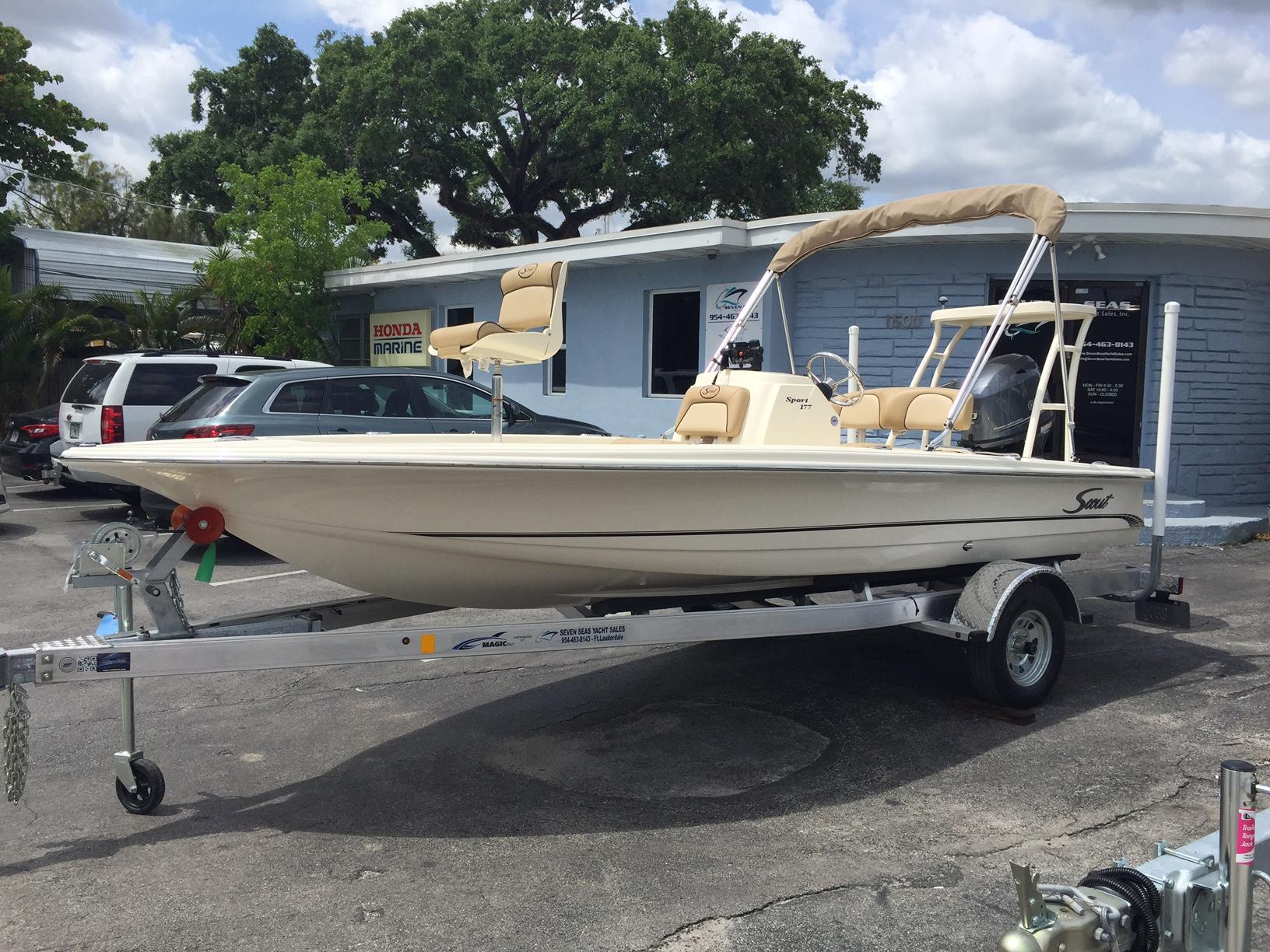 Scout 177 Sport 2025 Scout 177 Sport boat on a trailer in a dealership parking lot.