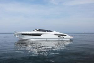 Windy 29 Huracán 2024 Windy 29 Huracán luxury boat on calm water under clear sky.