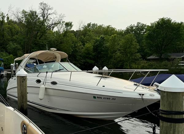 Sea Ray 280 Sundancer 2004 Sea Ray 280 Sundancer boat docked in a serene, wooded marina.