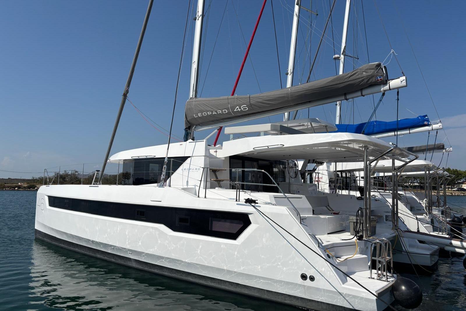 Leopard 46 2025 Leopard 46 catamaran docked in a marina, showcasing sleek design and modern features.