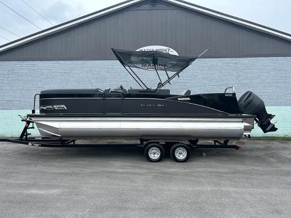 Avalon 2385 Catalina VRB 2025 Avalon 2385 Catalina VRB pontoon boat on trailer, parked outdoors.