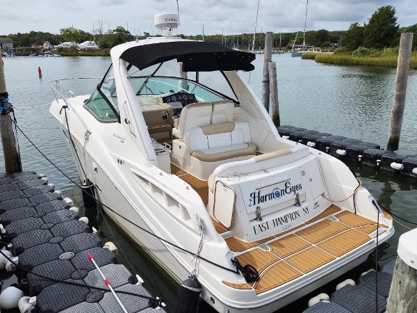 Sea Ray 310 Sundancer 2009 Sea Ray 310 Sundancer docked in a serene marina setting.