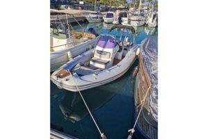 Grand G580 2019 Grand G580 boat docked in a marina, surrounded by other vessels.