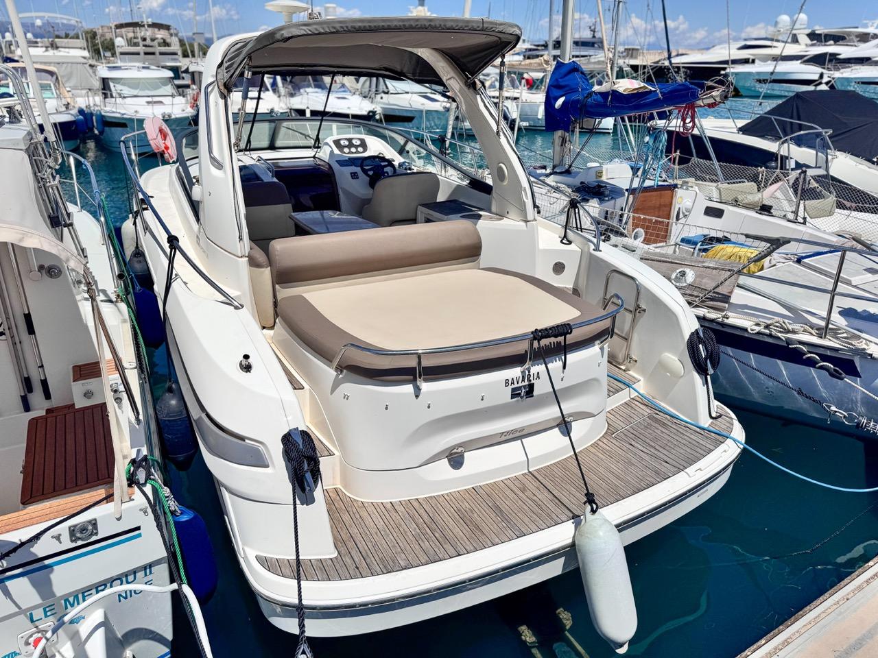 Bavaria 28 Sport Bavaria 28 Sport 2010 yacht docked in marina, featuring spacious deck and seating area.