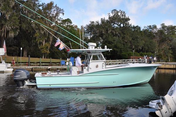 OBX Custom Carolina 32 2006 OBX Custom Carolina 32 boat on water, side view, with trees in background.