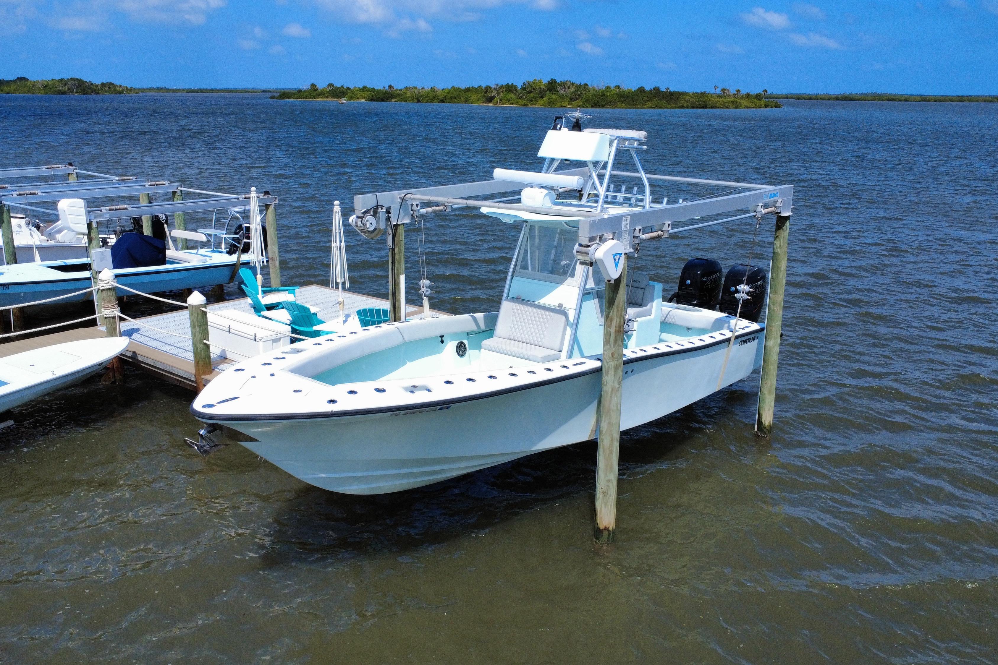 Conch 30 2018 Conch 30 boat docked on a lift in a scenic waterfront setting.