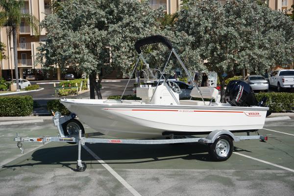 Boston Whaler 150 Montauk 2025 Boston Whaler 150 Montauk boat on trailer in parking lot.