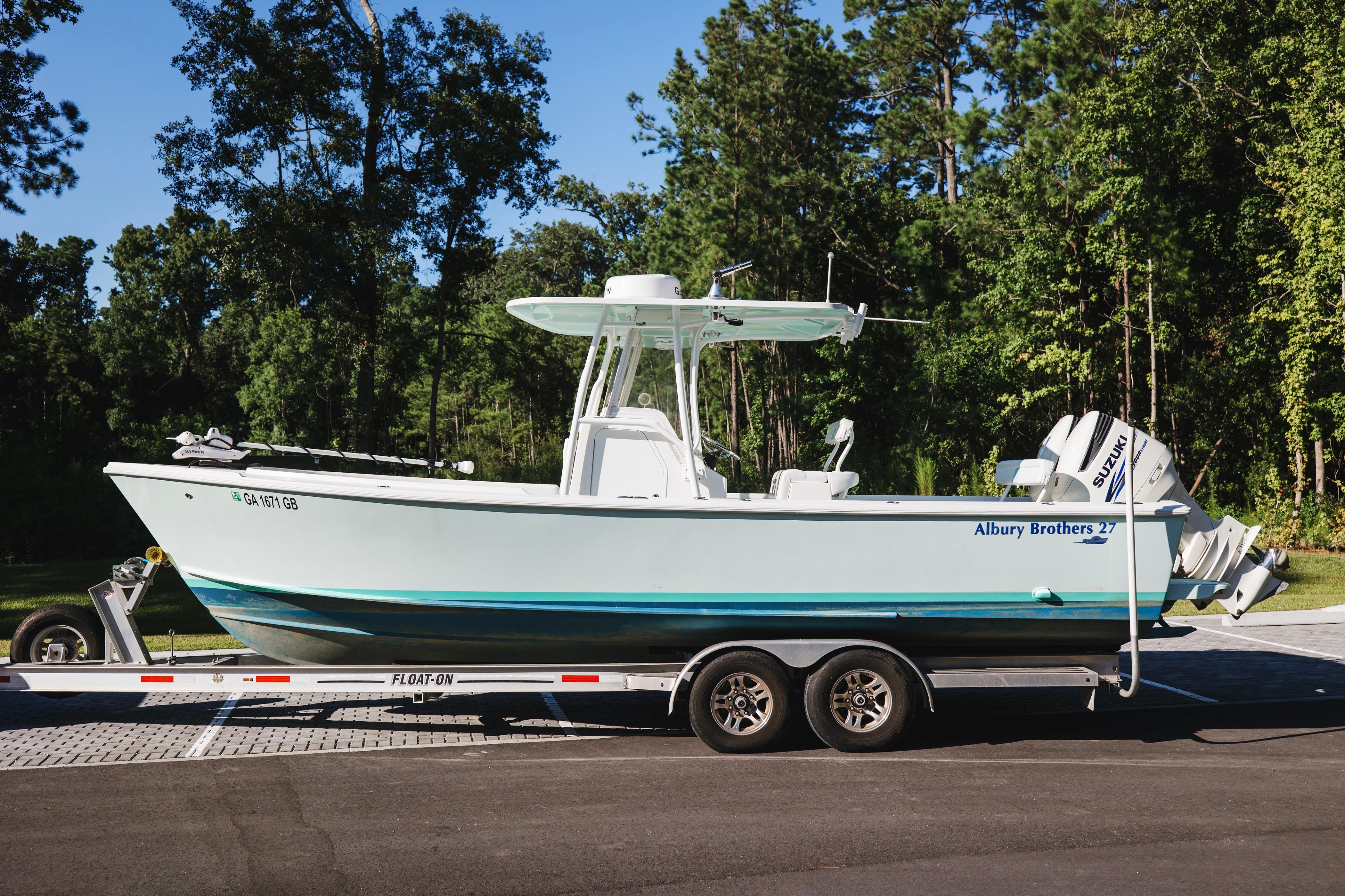 Albury Brothers center console 2017 Albury Brothers center console boat on trailer, surrounded by trees.