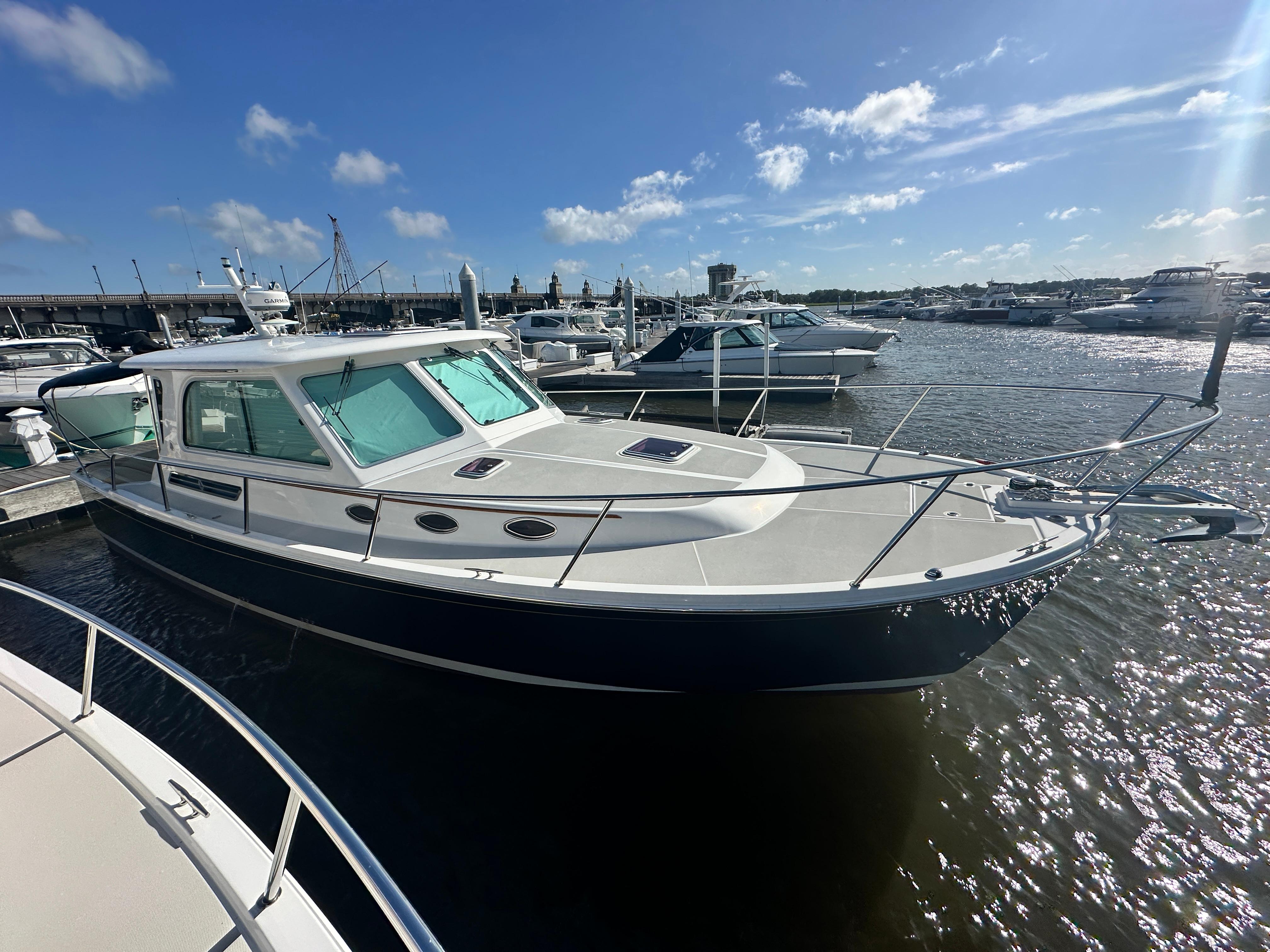 Back Cove 37 2014 Back Cove 37 boat docked at marina under clear blue sky.