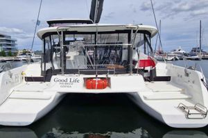 Lagoon 42 2024 Lagoon 42 catamaran "Good Life" docked in a marina, rear view.