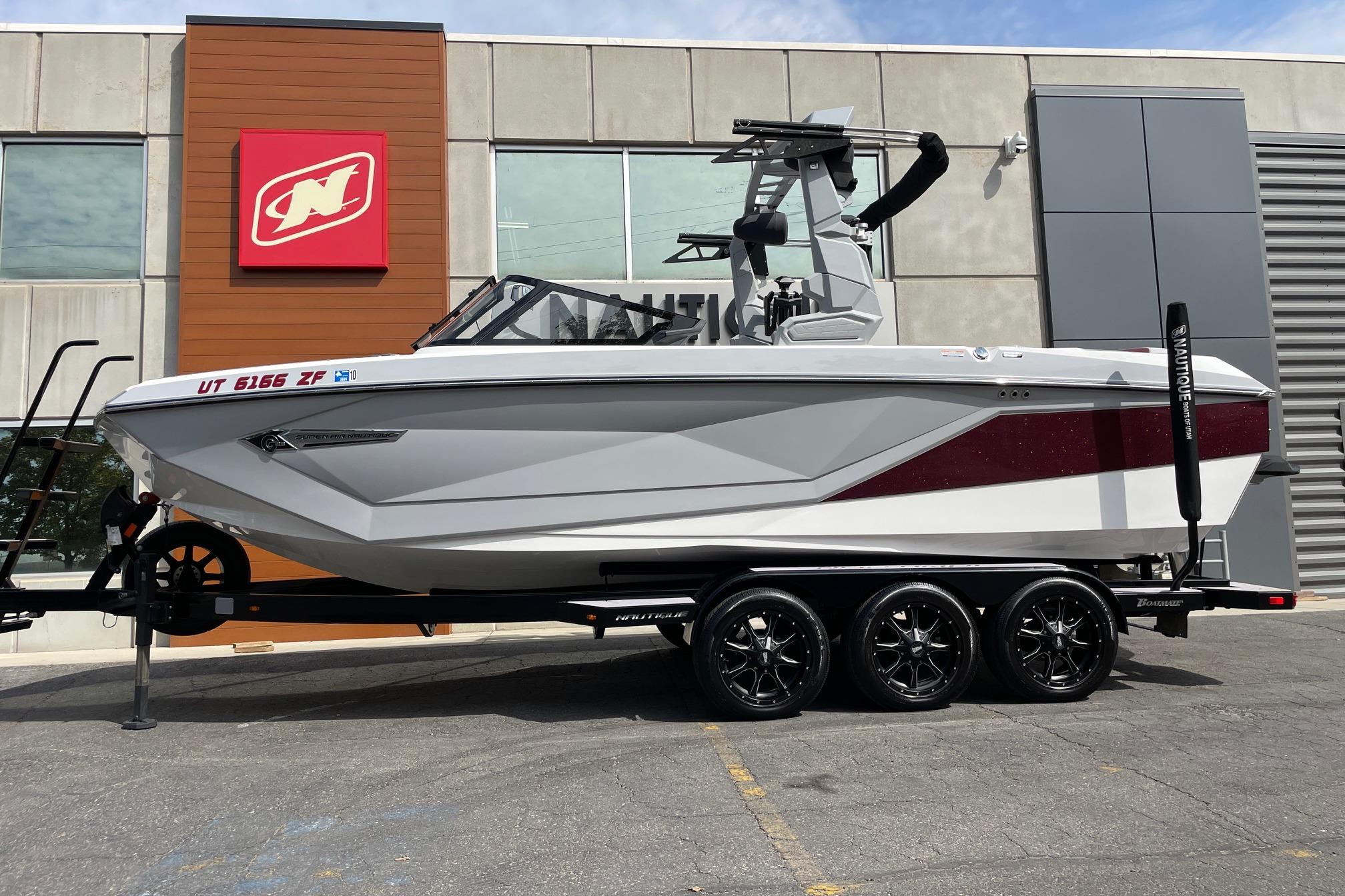 Nautique Super Air Nautique G23 2023 Nautique Super Air Nautique G23 boat on trailer, parked outside dealership.