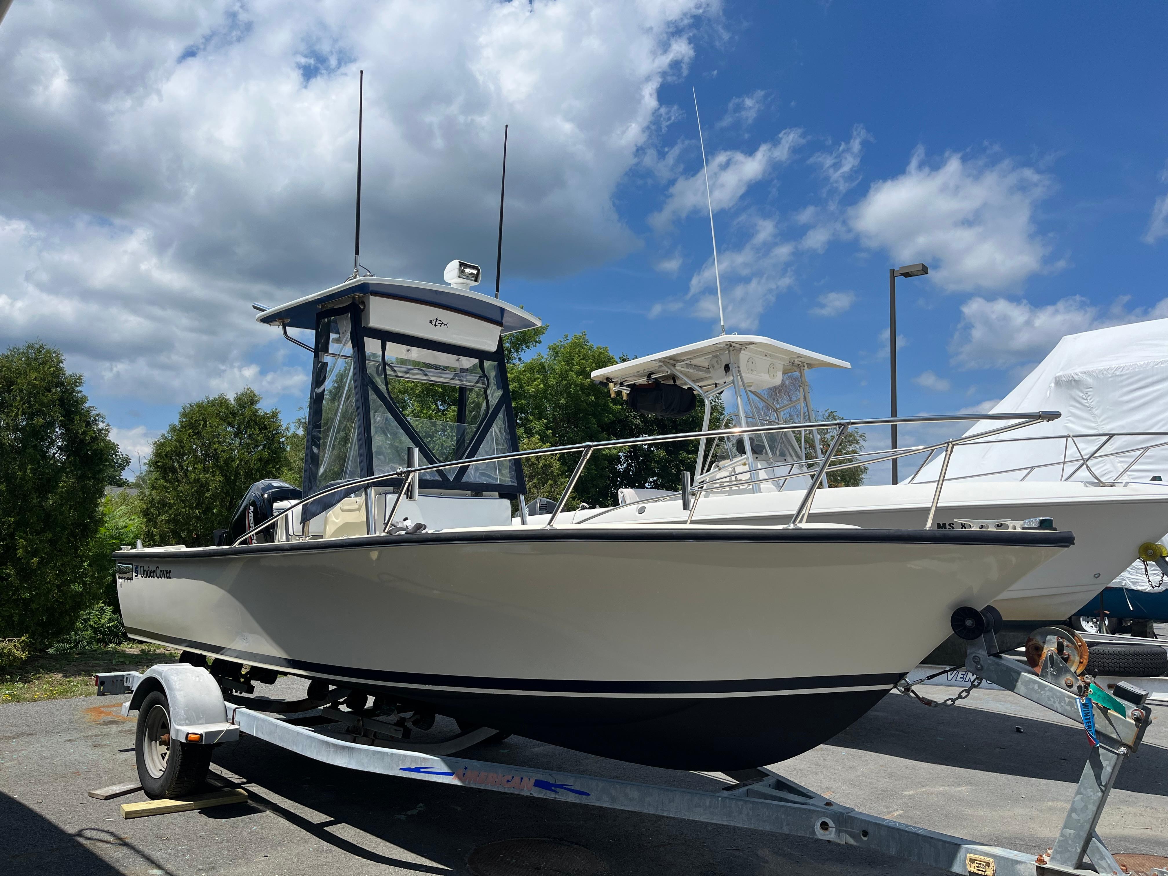 SeaCraft 20 Classic 1975 SeaCraft 20 Classic boat on trailer under blue sky with clouds.