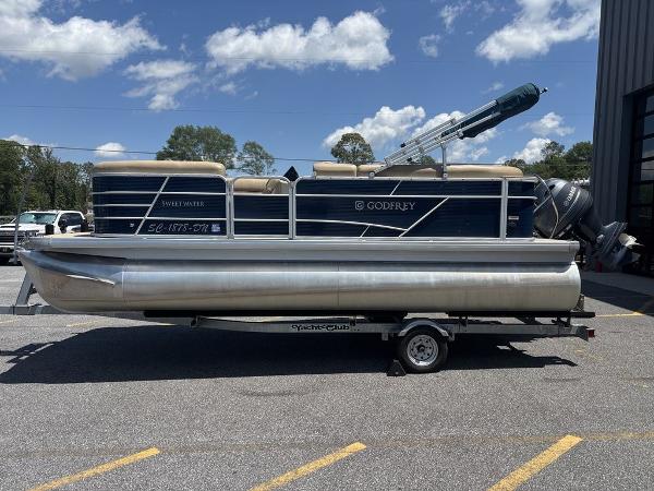 Godfrey SW 2086 C 2021 Godfrey SW 2086 C pontoon boat on trailer, parked outdoors under blue sky.
