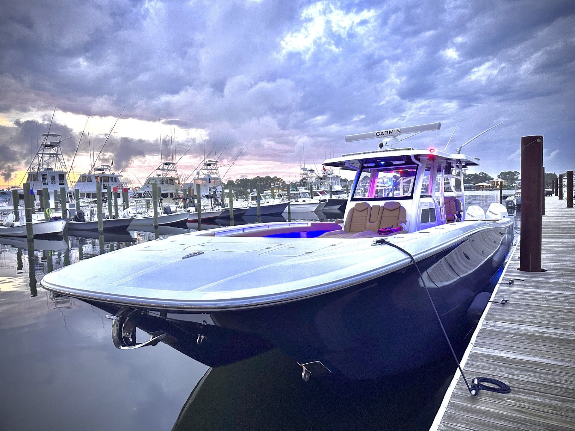 Invincible 46 Catamaran 2024 Invincible 46 Catamaran docked at marina under dramatic cloudy sky.