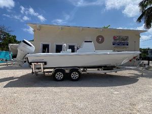 East Cape 25 Open 2024 East Cape 25 Open boat on trailer outside a building under a clear sky.