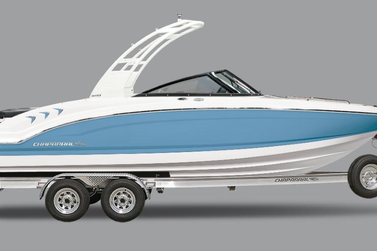 Chaparral 21 SSi 2026 Chaparral 21 SSi boat with blue hull on trailer, side view.