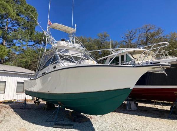 Albemarle 320 Express Fisherman 1998 Albemarle 320 Express Fisherman boat on dry dock, white hull, green bottom, clear sky.