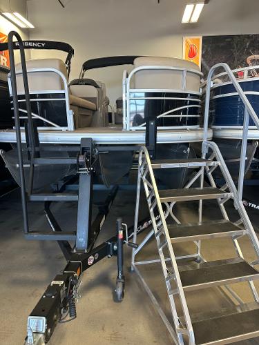 Sun Tracker SportFish 22 XP3 2022 Sun Tracker SportFish 22 XP3 pontoon boat on display with trailer and stairs.