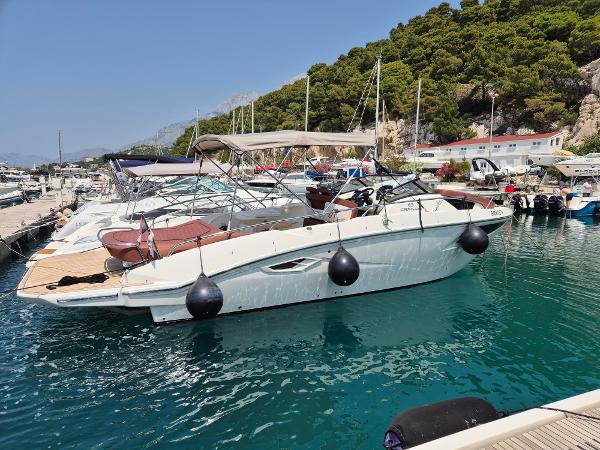 Cranchi E30 Endurance 2023 Cranchi E30 Endurance yacht docked in a scenic marina.
