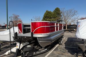 Sun Tracker Party Barge 18 DLX 2026 Sun Tracker Party Barge 18 DLX pontoon boat on trailer, vibrant red exterior.