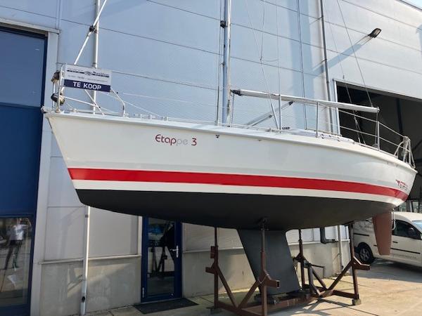 Etap 28i Sailboat Etap 28i 1991 model displayed for sale outside a building.