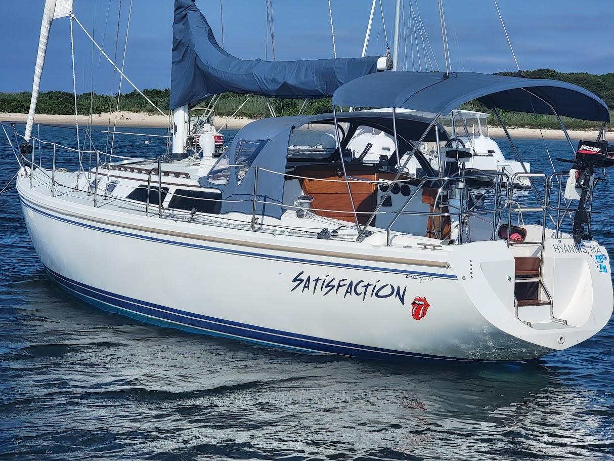 Catalina 36 Catalina 36 sailboat named "Satisfaction" anchored near a sandy shore, 1990 model.