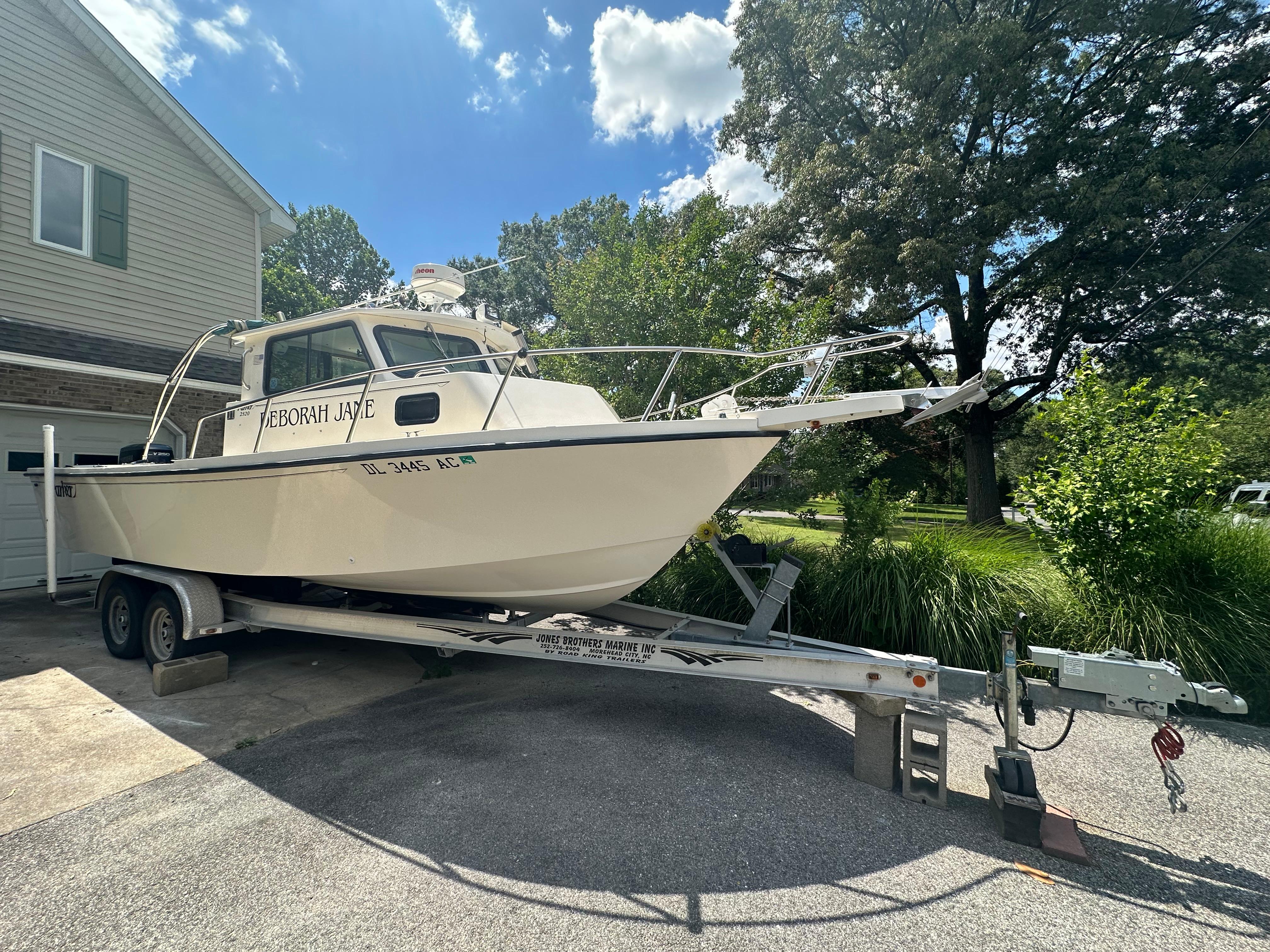 Parker 2520 Parker 1999 Parker 2520 boat on a trailer in a driveway, named Deborah Jaye.