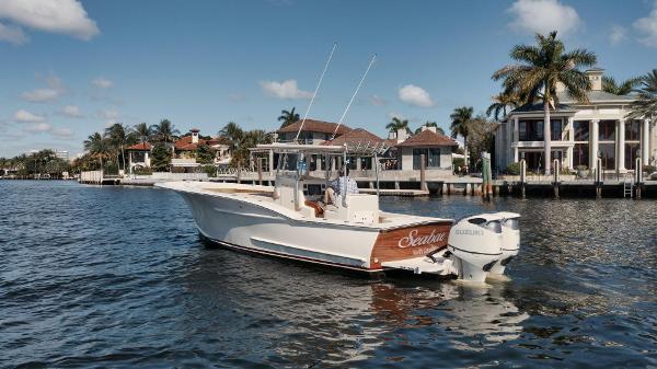 Custom Carolina 32 Open 2019 Custom Carolina 30 Open boat on water near luxury waterfront homes.
