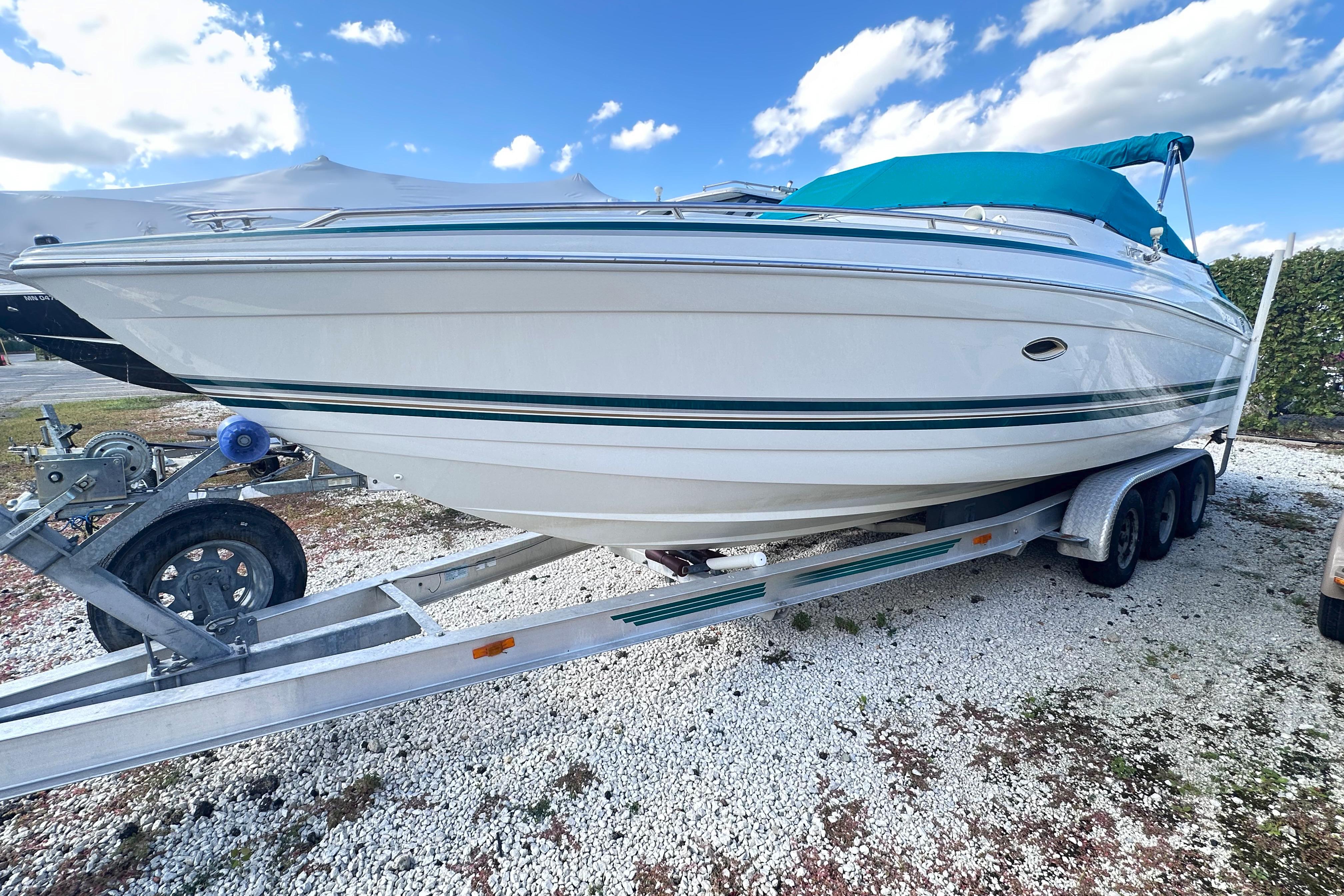Formula 280 Sun Sport 1998 Formula 280 Sun Sport boat on trailer under blue sky.