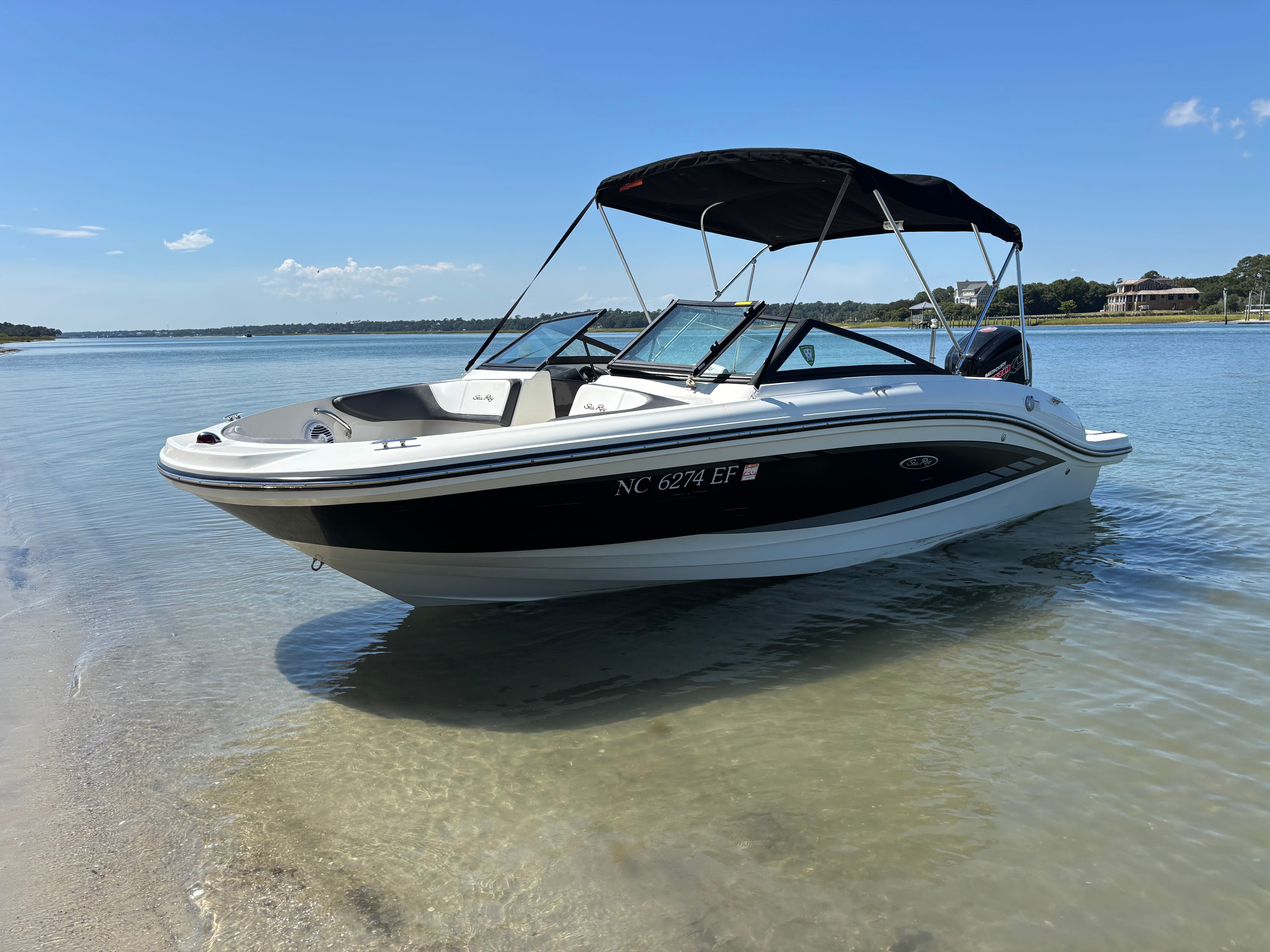 Sea Ray SPX 190 Outboard 2017 Sea Ray 190SPX-OB boat on calm water with clear blue sky.