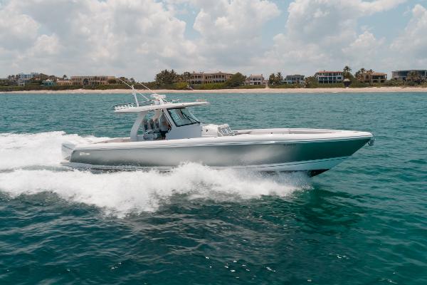 Intrepid 407 Nomad SE 2021 Intrepid 407 Nomad SE cruising on the ocean with coastal homes in the background.