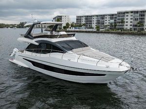Astondoa 52 Luxury 2021 Astondoa 52 yacht cruising on a calm waterway.