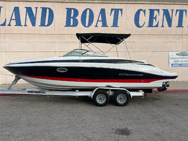 Crownline 270 SS 2016 Crownline 270 SS boat on a trailer at a boat center.