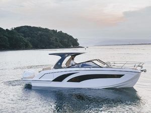 Hanover 347 2024 Hanover 347 boat cruising on serene waters near a lush island.