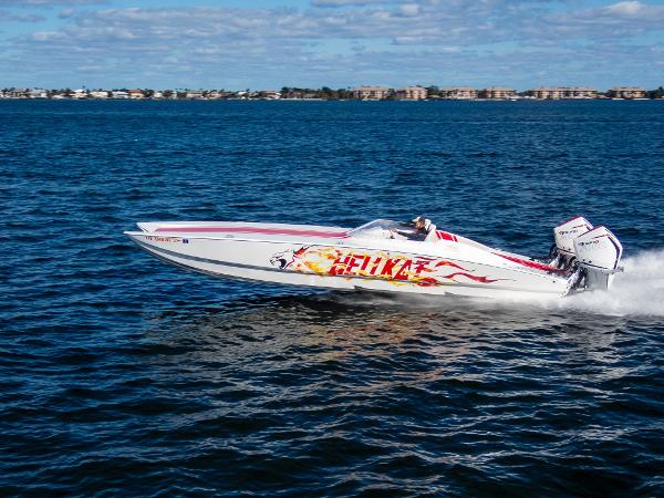 HellCat 32 Wide Body 2022 HellCat 32 Wide Body speedboat cruising on open water.