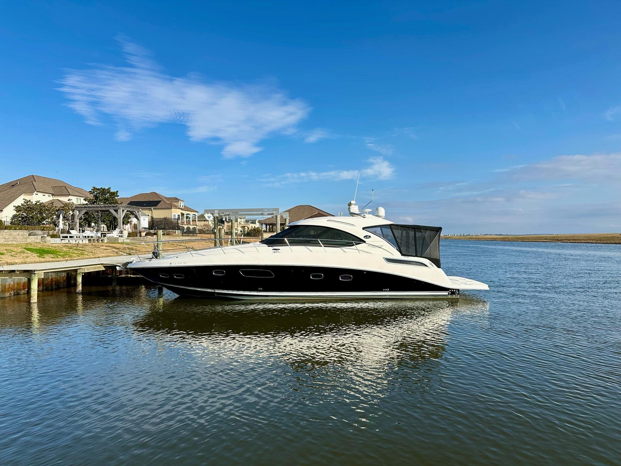 Sea Ray 4300 Sundancer 2009 Sea Ray 4300 Sundancer yacht docked in a serene waterfront setting.