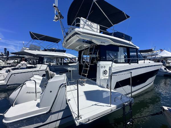 Jeanneau NC1295 Fly 2025 Jeanneau 1295 yacht docked, featuring sleek design and modern amenities.