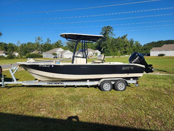Carolina Skiff 24 Ultra Elite 2021 Carolina Skiff 24 Ultra Elite boat on trailer in grassy yard.