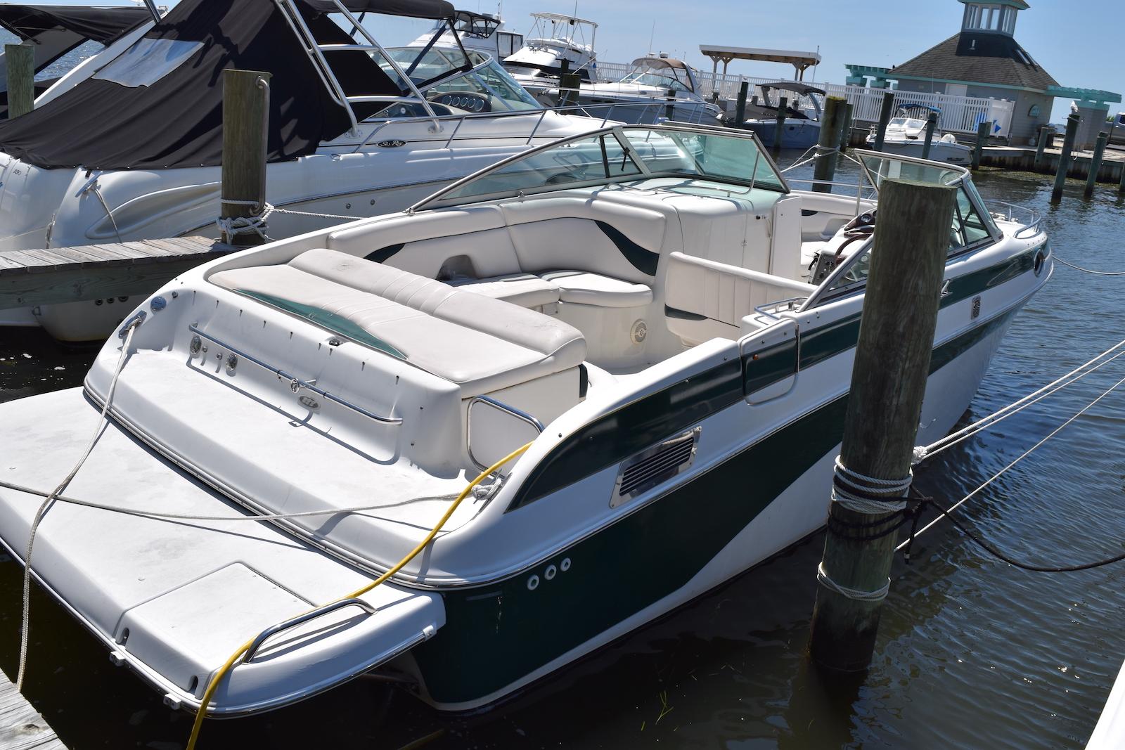 Crownline 288 BR 2001 Crownline 288 BR boat docked at marina, featuring spacious seating and sleek design.