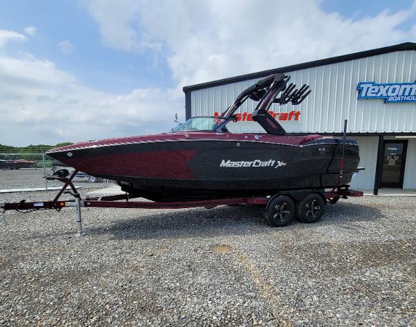 MasterCraft XStar S 2023 MasterCraft XStar S boat on trailer outside dealership.