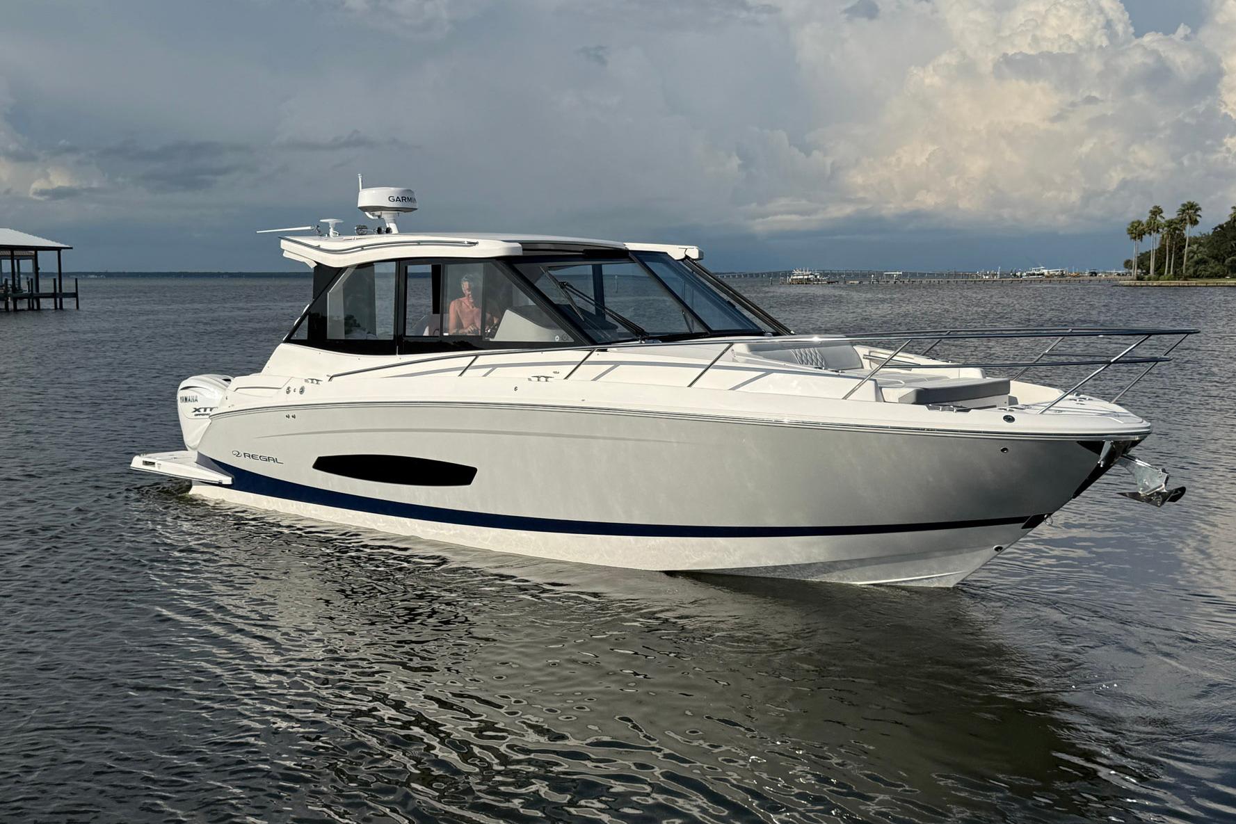 Regal 36 XO 2025 Regal 36 XO luxury yacht on calm waters under a cloudy sky.