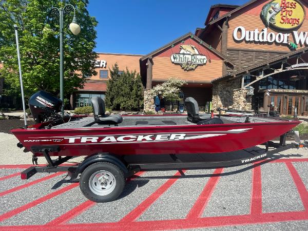 Tracker Panfish 17 2025 Tracker Panfish 17 boat displayed outside Bass Pro Shops, featuring a sleek red design.