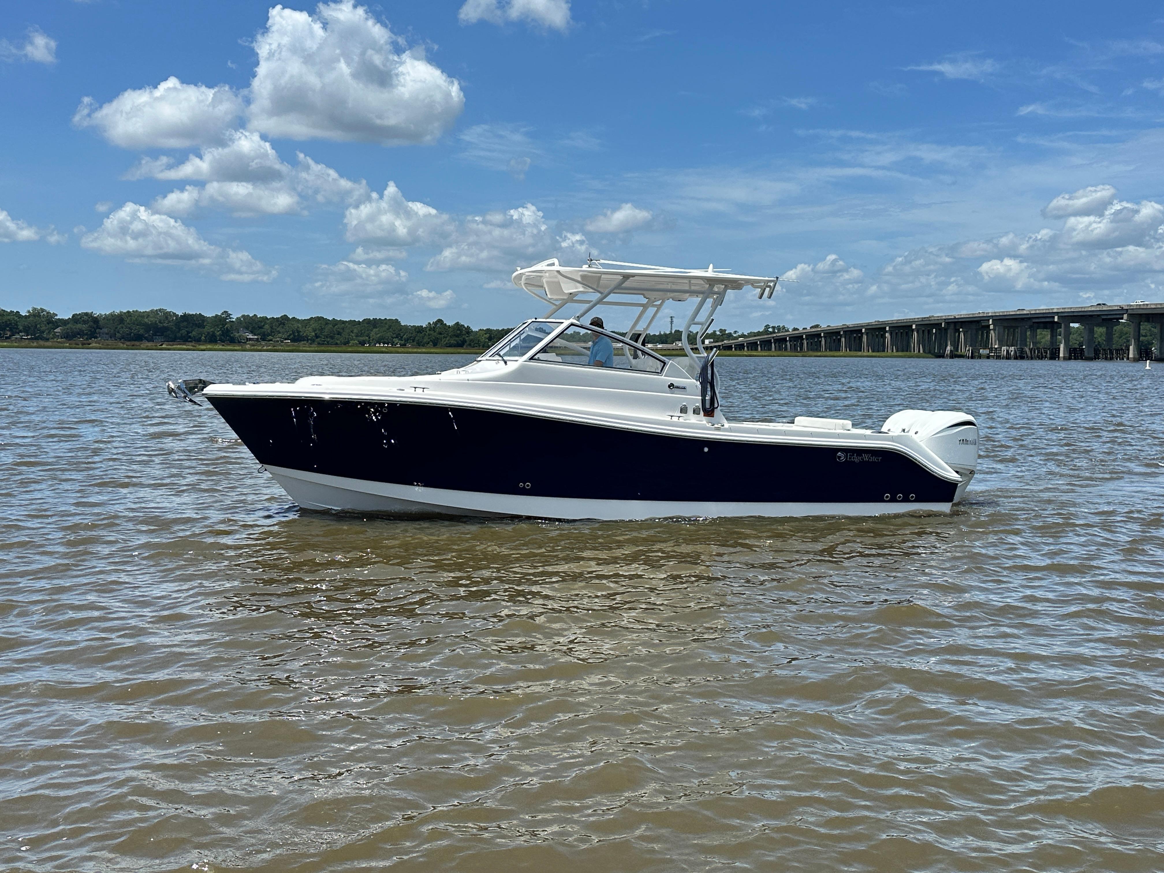 Edgewater 280 CX 2023 Edgewater 280 CX boat on calm water under a blue sky.